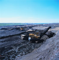 Open-cast mining of tar sands. Image credit: A handful of tar sands. Image credit: ostseis.anl.gov