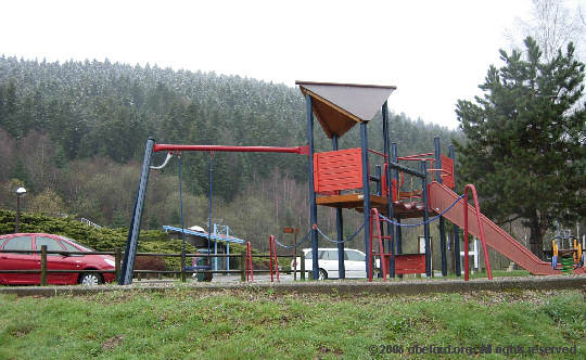 the 
            play area, with snow-topped wooded 'mountains' behind
