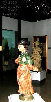 Two statues of pilgrims. The nearer wears  the pilgrim's symbol of a shell.