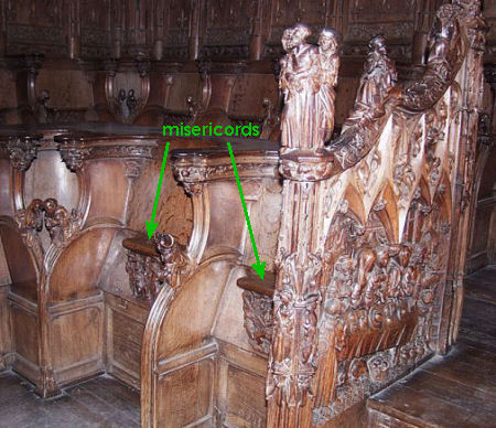 Two choir stalls at Amiens cathedral with their misericords marked.